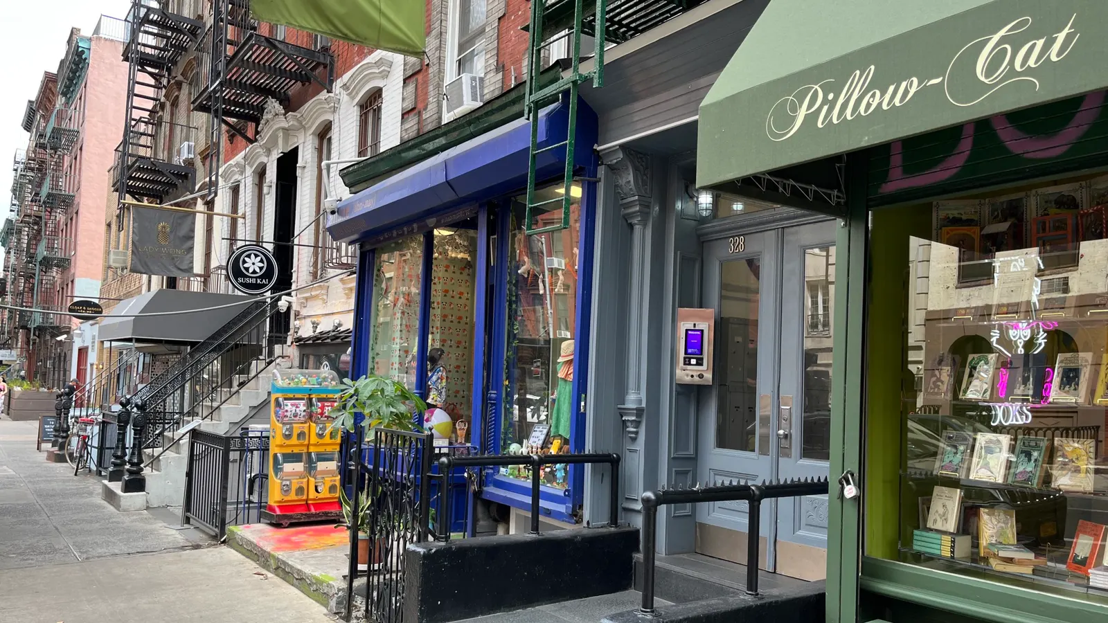 A row of independent shopfronts and awnings on a city street.